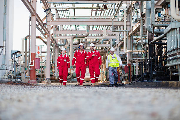 Workers walking at chemical plant  oil refinery stock pictures, royalty-free photos & images