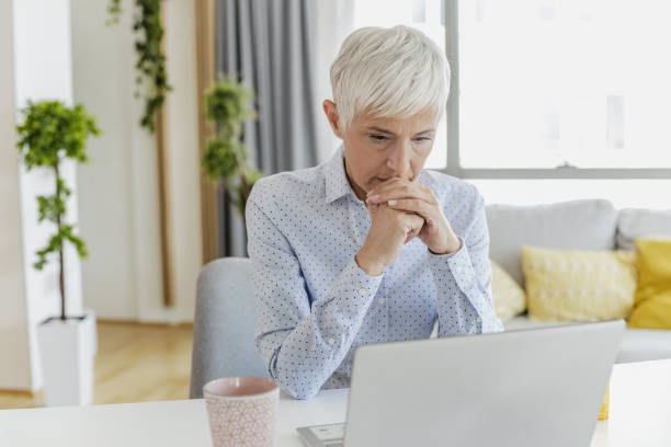 Working from home for mature people can be stressful and exhausting stock photo