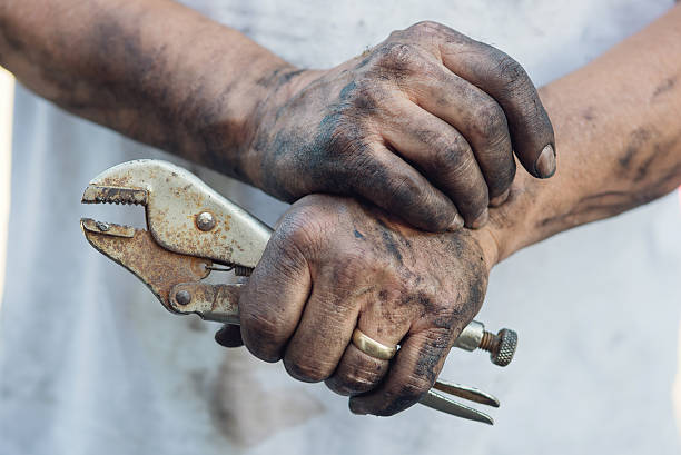 Working Man’s Greasy hands, DIY A man fixes his own car. Resting. toughness stock pictures, royalty-free photos & images