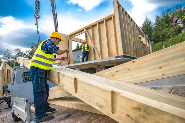 Working on a prefabricated house Construction workers during construction of a prefabricated house on concrete foundation. prefabricated building stock pictures, royalty-free photos & images