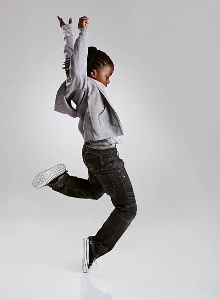 Working on his hip hop routine A young boy hip-hop dancing in the studio boy jumping stock pictures, royalty-free photos & images
