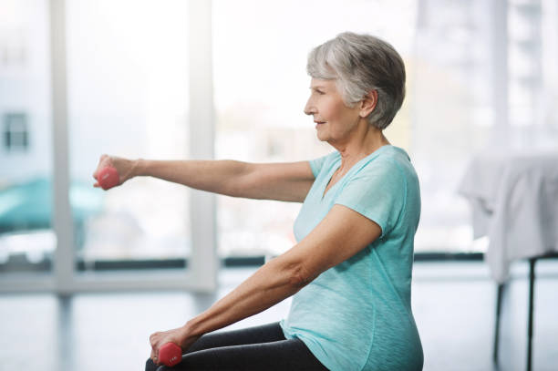 Working on keeping herself healthy Cropped shot of a healthy senior woman working out with dumbbells osteoporosis photos stock pictures, royalty-free photos & images