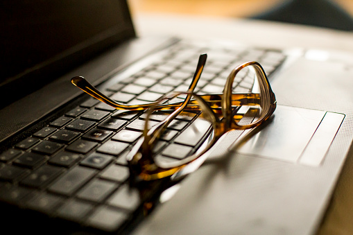 Laptop and reading glasses.
