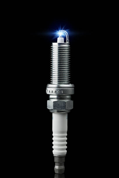 working spark plug with blue sparkle working spark plug with blue sparkle, isolated on black iridium stock pictures, royalty-free photos & images