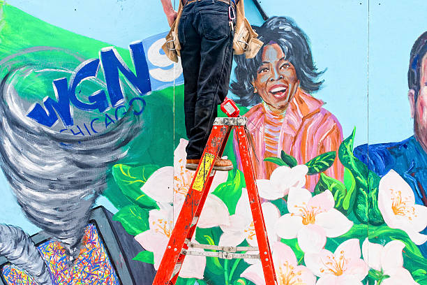 Workman On Ladder, Wall Mural of Oprah Winfrey stock photo