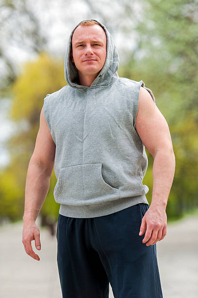 Workout man in hood resting. Outdoor. stock photo