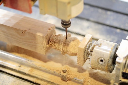 Workpiece processing on CNC wood turning lathe machine. Selective focus.