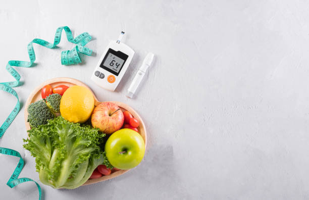 World diabetes day and healthcare concept. Diabetic measurement set, measure tape and healthy food eating nutrition in plate on stone background. stock photo