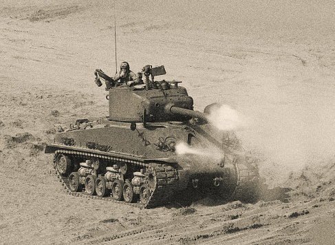 World War 2   Tank Firing Weapon on Battle Field. Omaha Beach. Normandy invasion