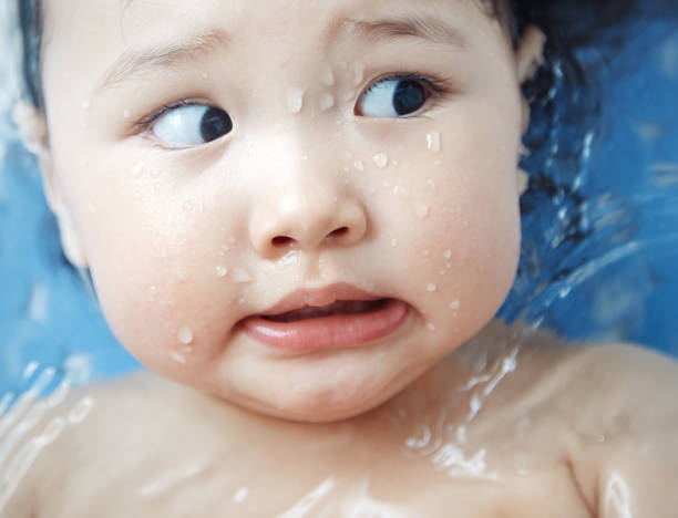 Worried child in the bathtub. Close-up horizontal photo stock photo