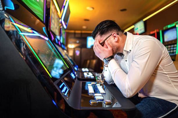 /worried-man-loosing-his-money-on-a-slot-