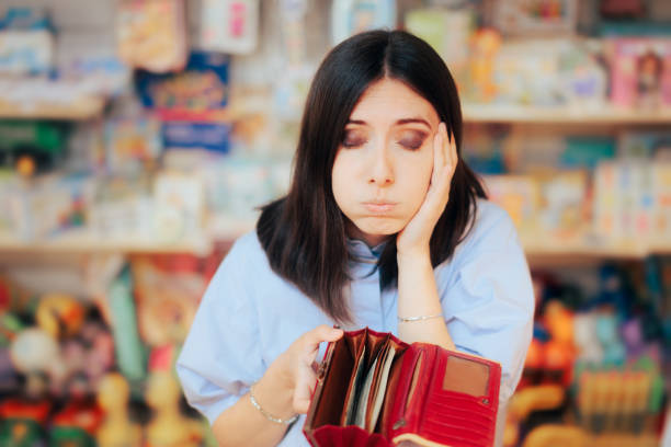 Worried Woman Checking her Wallet in a Store stock photo