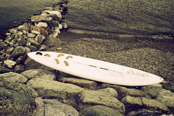 wrecked surfboard stock photo