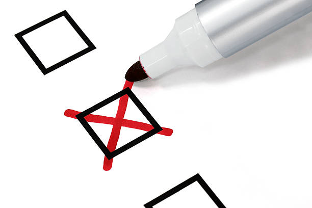 Writing a cross on checkbox Felt tip pen writing a red cross mark on a checkbox cross shape photos stock pictures, royalty-free photos & images