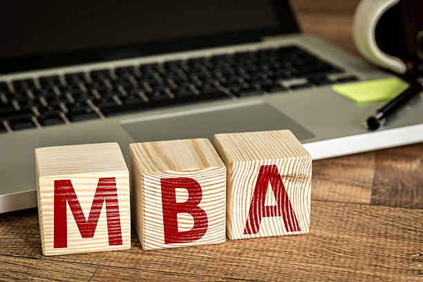 MBA written on a wooden cube MBA written on a wooden cube in front of a laptop MBA stock pictures, royalty-free photos & images