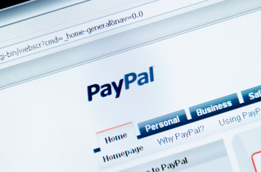 Florence, Italy - March 16, 2011: Close up of the www.paypal.com web pages. Paypal is an online payment system that allows any business or consumer with an email address to send and receive payments. The browser is Mozilla Firefox.