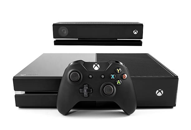 Xbox One Nashville, Tennessee, USA - November, 30th 2013: An isolated photograph of the new Xbox One video game console, sold by Microsoft, with a kinect motion sensor and the Xbox controller leaning against the front. Shot against a white background in Nashville TN. xbox stock pictures, royalty-free photos & images