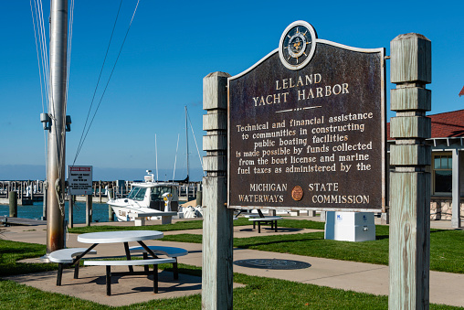 A sign gives info on the yacht harbor in the Leland Historic District (aka Fishtown) in Leland, Michigan, a small town on the Leelanau Peninsula outside Traverse City, Michigan. It is a very popular tourist destination.