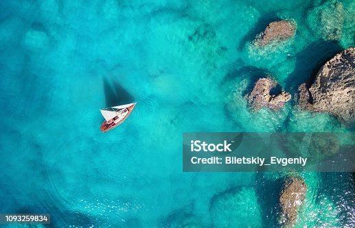 istock Yacht on the sea from top view. Turquoise water background from top view. Summer seascape from air. Travel concept and idea 1093259834