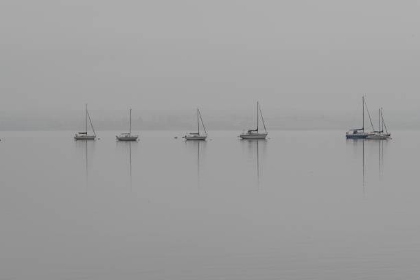 Yachts moored on calm waters on a misty day Yachts moored on calm waters of Strangford Lough, County Down (Norther Ireland) on a misty day. strangford lough stock pictures, royalty-free photos & images