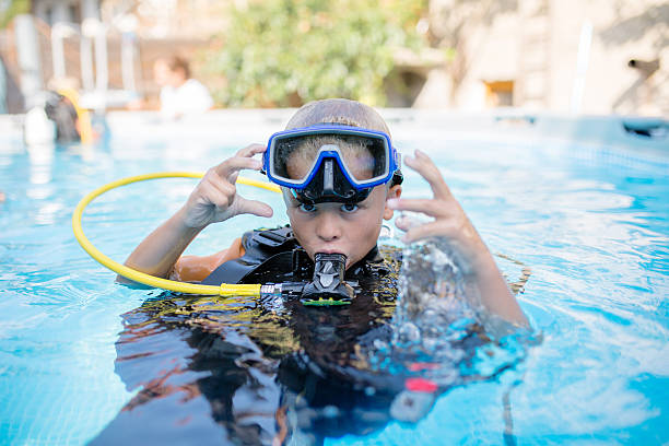 6 year old boy ready for scuba diving adventure stock photo