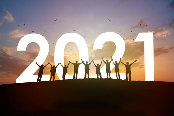 2021 year with team together Silhouette Group of people rise arm up with 2021 and beautiful sunset background. New year success, Believe and team together concept. new years day stock pictures, royalty-free photos & images