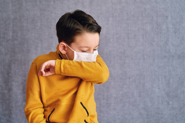 6-7 years old child wearing surgical mask for prevention. stock photo