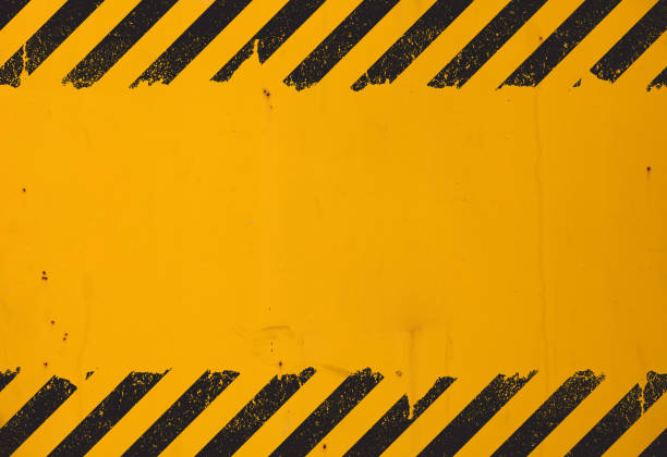 Yellow background with black grunge hazard sign stock photo