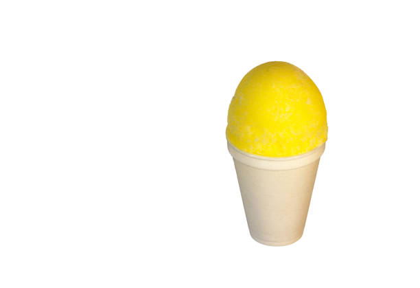 Yellow, banana or lemon, Shaved Ice, snow cone or shave ice in a white cup on a white background. stock photo