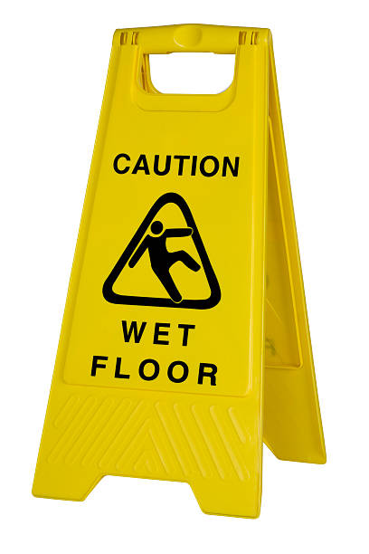 Yellow caution wet floor sign on white background stock photo