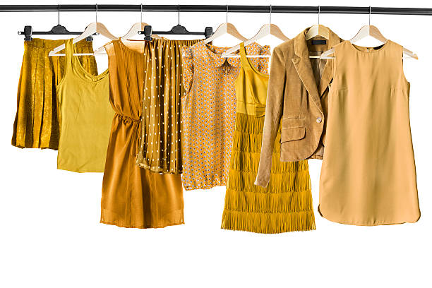 Yellow clothes on clothes racks Set of yellow clothes on clothes racks isolated over white clothes rack stock pictures, royalty-free photos & images