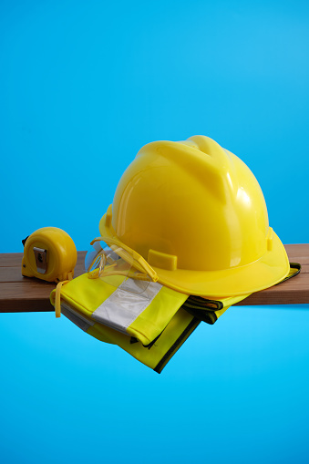 yellow construction safety equipment against blue background