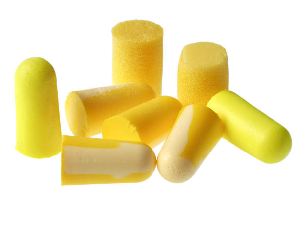 Yellow earplugs isolated on white stock photo