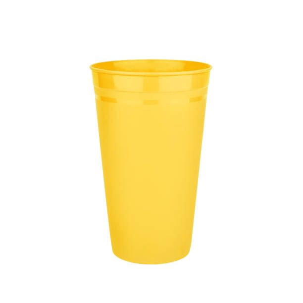 Yellow empty plastic cup white background isolated closeup, disposable blank drink glass, beverage, cocktail, cold water, hot coffee mug, tea, fruit juice, tableware design, utensil, container mockup stock photo