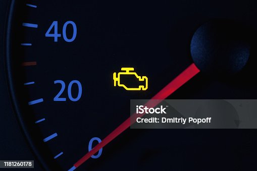 istock yellow engine check engine icon on car dashboard, black background 1181260178