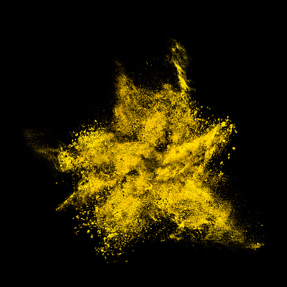 Abstract exploding black powder isolated on black background.