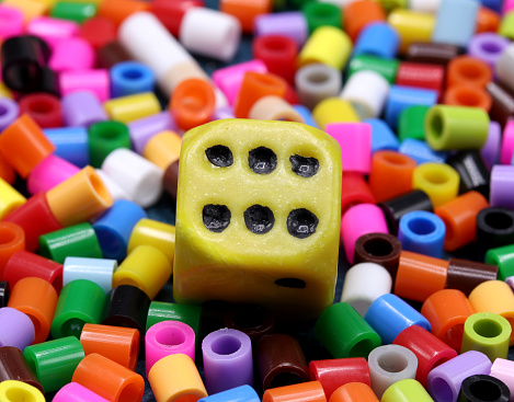 yellow game dice on a colored background