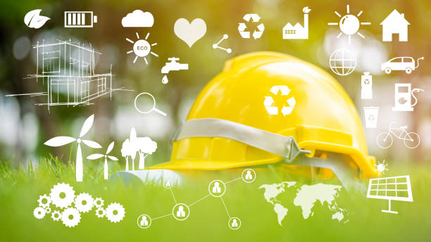 gele helm op groen met ecologisch pictogram - duurzaam bouwen stockfoto's en -beelden