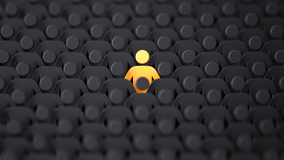 Yellow human shape among dark ones. Standing out of crowd concept