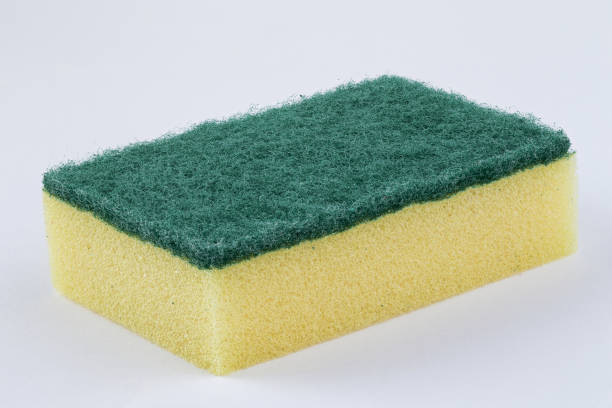 Yellow kitchen sponge against on white background stock photo