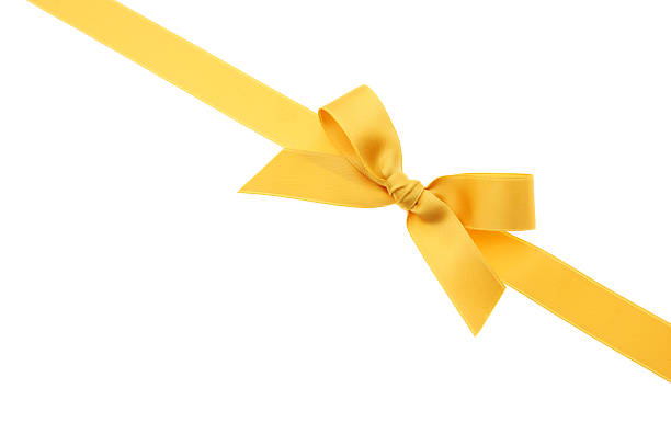 Yellow lace and bow over a white canvas for a Christmas gift stock photo