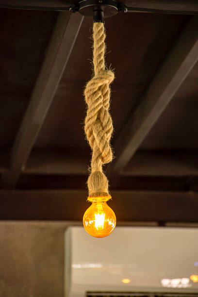 Yellow light bulb The sphere hanging with a rope. stock photo