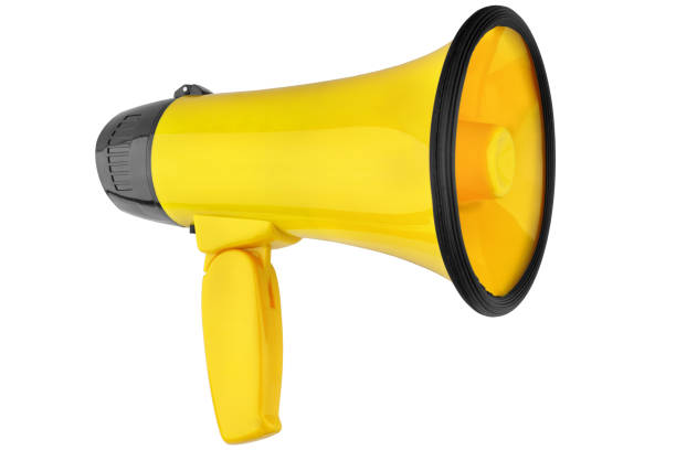 Yellow megaphone on white background isolated close up, hand loudspeaker design, loud-hailer or speaking trumpet, yellow press symbol, gutter press sign, tabloid or journalism icon, media illustration stock photo