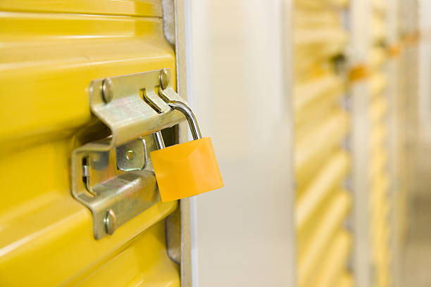 Yellow metal storage locker with padlock stock photo