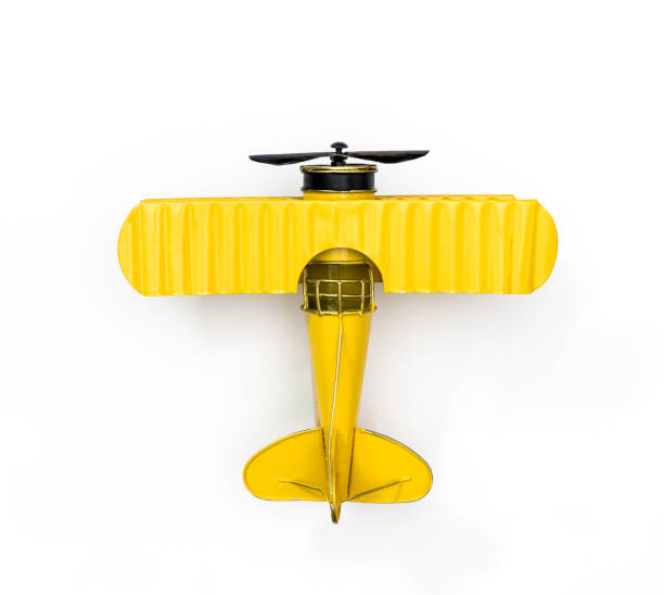 gele metalen speelgoed vliegtuig geïsoleerd op wit - speelgoedkisten stockfoto's en -beelden