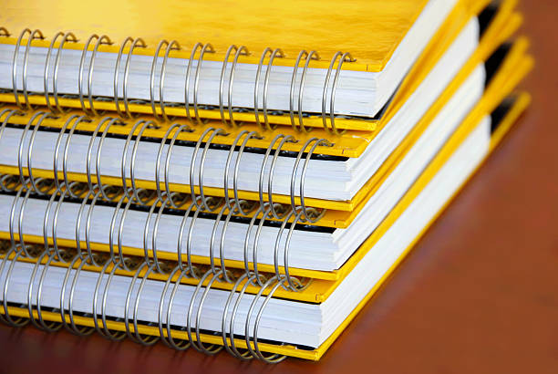 Yellow notebooks stack stock photo