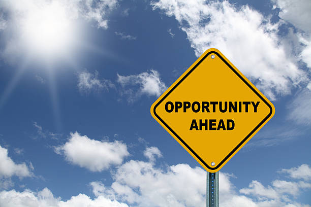 Yellow opportunity ahead road sign with sky Yellow opportunity ahead road sign against a beautiful blue sky opportunity stock pictures, royalty-free photos & images
