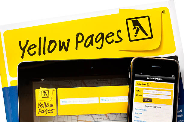 Yellow Pages Online "Melbourne, Australia - January 25, 2012:  Yellow Pages telephone directory, with iPad 2 and iPhone running Yellow Pages apps." white pages directory stock pictures, royalty-free photos & images