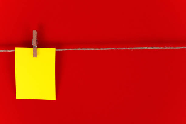 yellow paper. Red background, copy space. stock photo