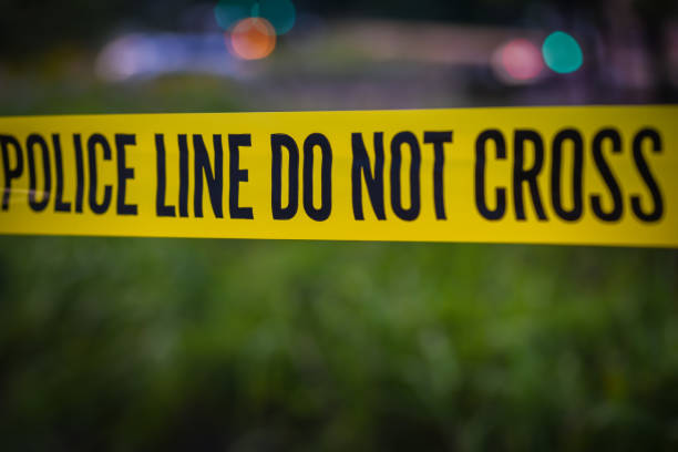 Yellow police tape Police barrier tape at crime scene murder stock pictures, royalty-free photos & images